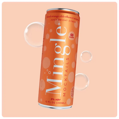 Orange can of blood orange mimosa mocktail with bubbles against a light peach background