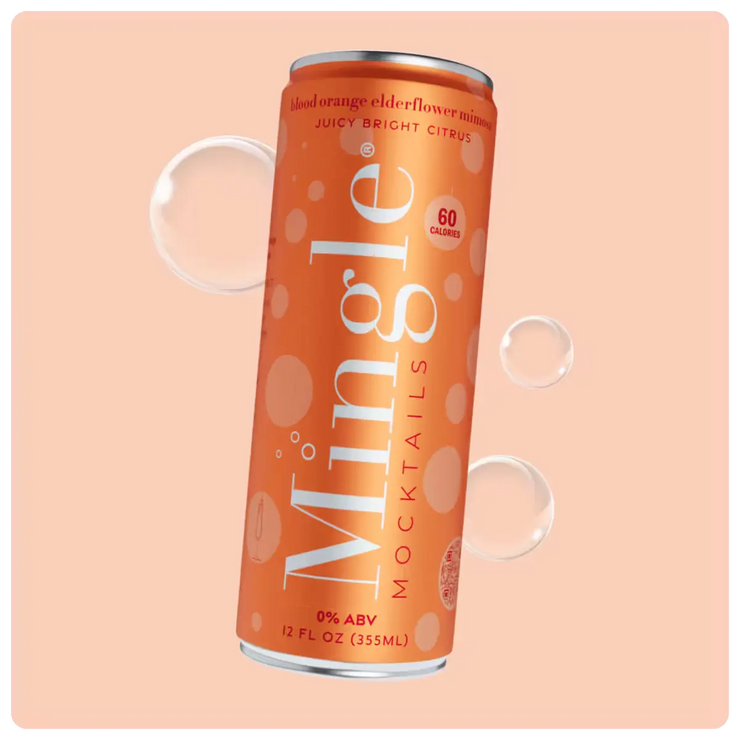 Orange can of blood orange mimosa mocktail with bubbles against a light peach background