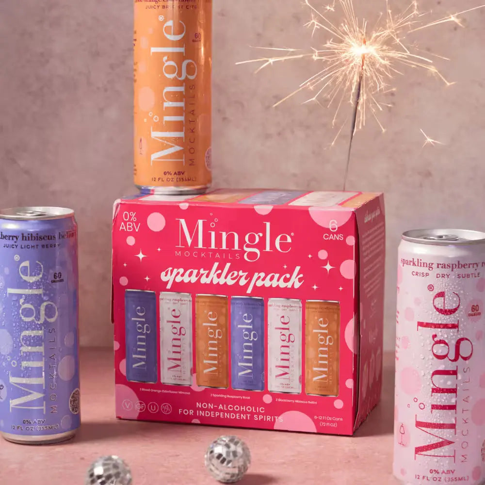 Mingle Mocktails Sparkler Pack displayed with individual cans and a lit sparkler, set on a pink background